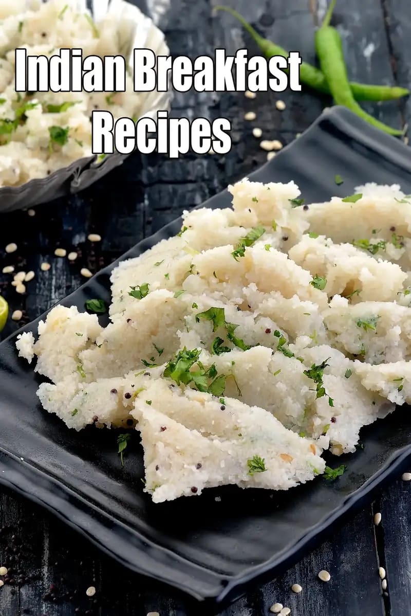 Indian vegetarian breakfast dish of soft suji upma garnished with fresh coriander and mustard seeds served on a black plate