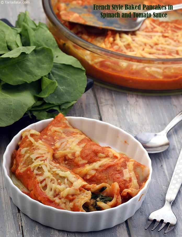 French Style Baked Pancakes in Spinach and Tomato Sauce recipe | Tarla Dalal