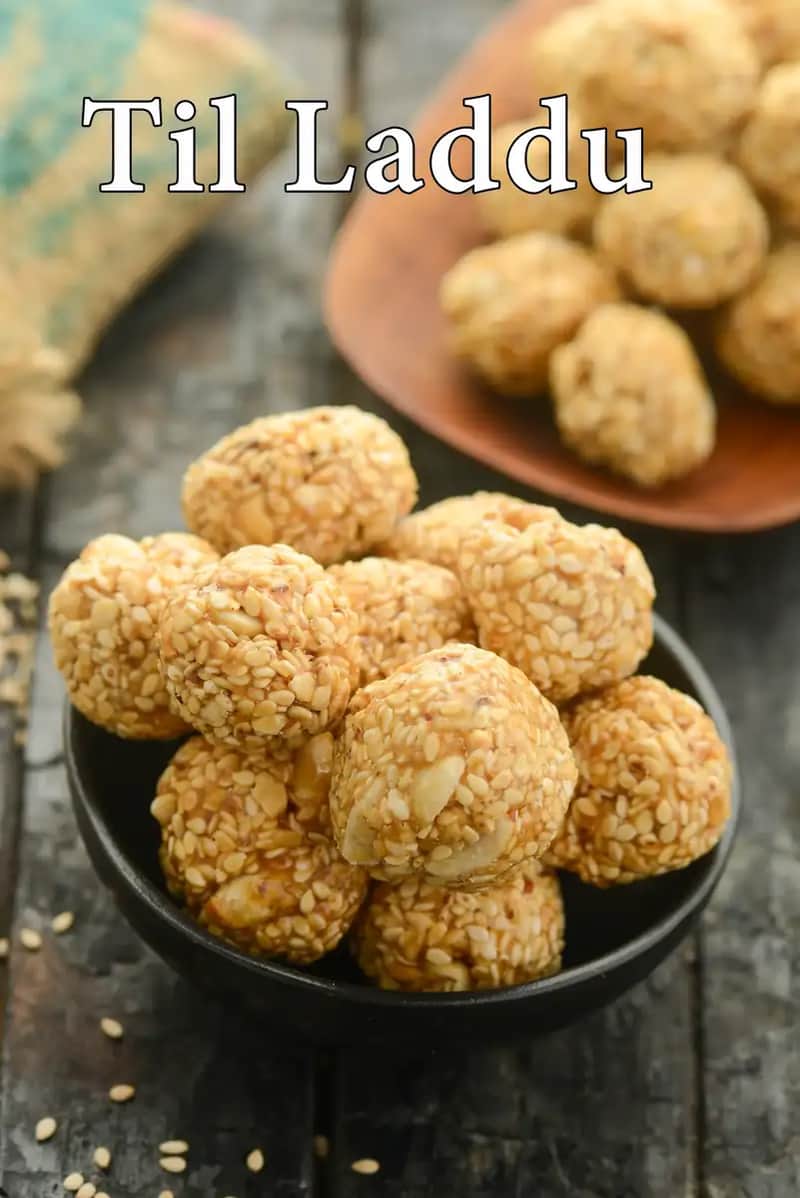 A close-up of Til Laddu (Sesame Seed Balls) served in a black bowl, with more laddus in the background.