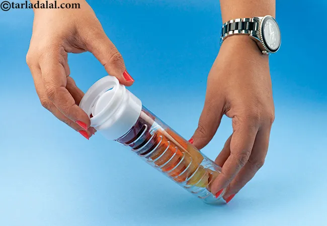 Place the cut fruits into the infuser tube