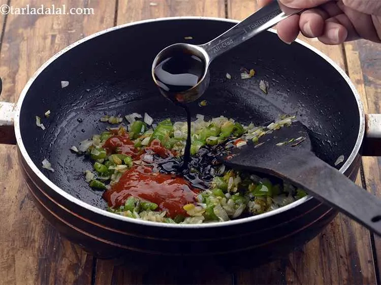 Step 22 – <p>Now add the soy sauce and red chilli sauce and stir for a few seconds.</p>