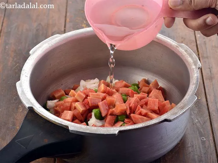 Step 6 – <p>Finally, add 1 cup of water in the pressure cooker.</p>