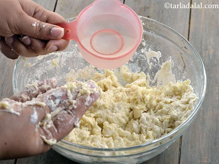 Step 35 – <p>Add water little by little and knead into a soft dough.&nbsp;</p>