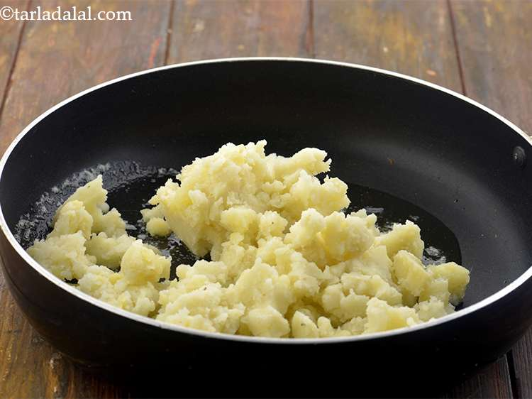 Step 4 – <p>Now, add the potatoes into the pan. Mash the potatoes well with a potato masher …