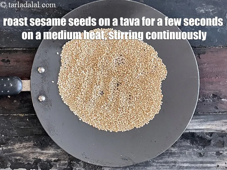 Step 6 – Roast sesame seeds on a tava on medium heat for a few seconds, while stirring …