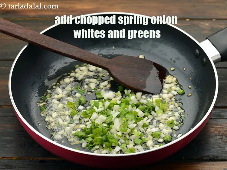 Step 27 – Add 1/4 cup&nbsp;finely&nbsp;<a href="https://www.tarladalal.com/glossary-chopped-spring-onion-whites-815i">chopped spring onions whites</a>&nbsp;and&nbsp;<a href="https://www.tarladalal.com/glossary-spring-onion-greens-hare-pyaz-ke-patte-445i">greens</a>.
