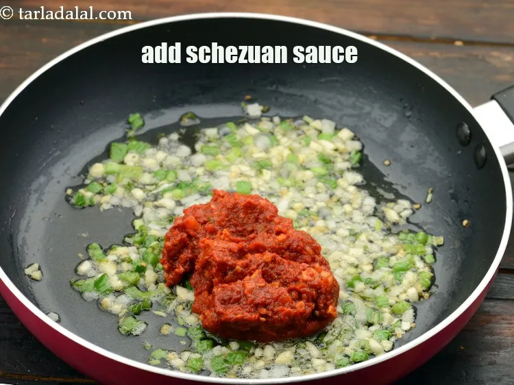 Step 29 – Add 5 tbsp&nbsp;<a href="https://www.tarladalal.com/glossary-schezwan-sauce-schezuan-sauce-1872i">schezuan sauce</a>.