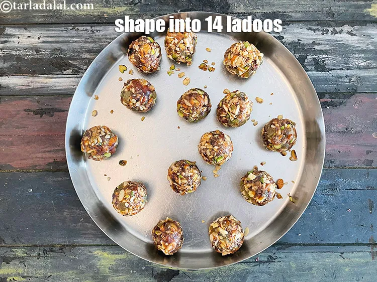 Step 25 – <span style="font-family:Arial,sans-serif">Grease your hands with oil. Easier to roll the ladoo balls.&nbsp;Shape into 14 big …