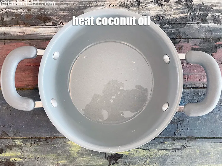 Step 10 – <span style="font-family:Arial,sans-serif">To make dry fruit barfi, heat&nbsp;1 tbsp&nbsp;<a href="https://www.tarladalal.com/glossary-coconut-oil-nariyal-ka-tel-1186i"><span style="color:blue">coconut oil</span></a>&nbsp;or ghee in a non-stick …