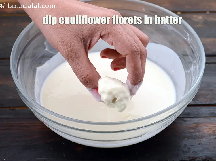 Step 19 – Dip a few cauliflower florets in the prepared batter.