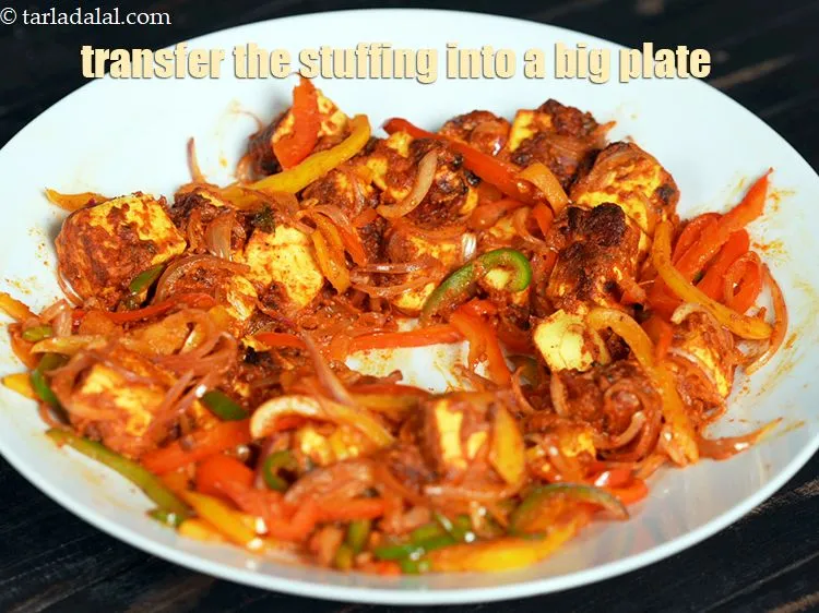 Step 27 – Transfer the stuffing into a big plate and push it towards the sides of the …