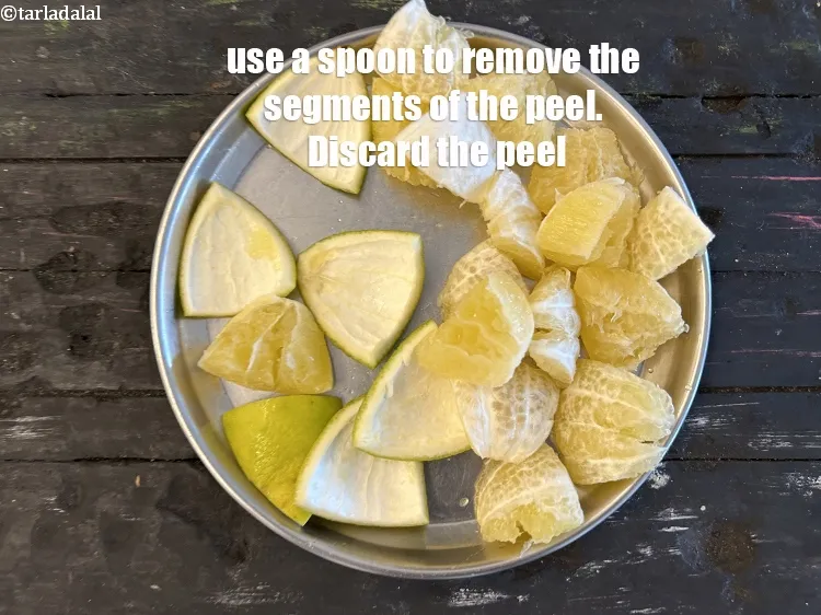 Step 10 – Use a spoon to remove the segments from the peel.&nbsp;Discard the peel.