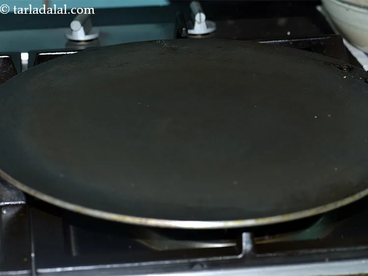 Step 25 – Further, heat a non-stick tawa.