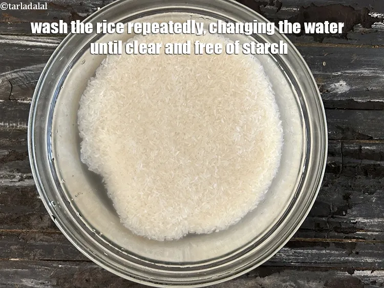 Step 6 – Wash the rice repeatedly, changing the water until it runs clear and free of starch.