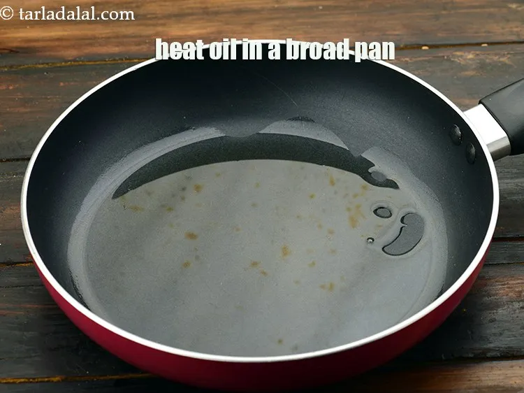 Step 22 – Heat 2 tbsp&nbsp;<a href="https://www.tarladalal.com/glossary-oil-671i">oil</a>&nbsp;in a broad non-stick pan.