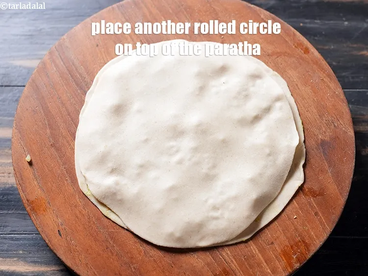 Step 38 – Place another rolled circle on top of the paratha and gently press the edges together …