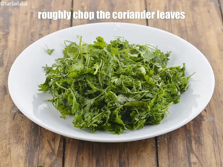 Step 12 – <meta charset="UTF-8" /> Roughly chop the coriander leaves for the <strong>Teekha</strong>&nbsp;<strong>Pudina Chutney (Spicy Mint Chutney)</strong>. …
