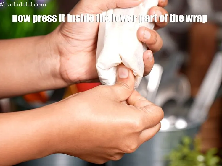 Step 61 – Now press it inside the lower part of the wrap as show in the image.