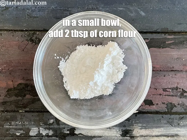 Step 11 – For cornflour mixture, in a small bowl, add 2 tbsp of corn flour.