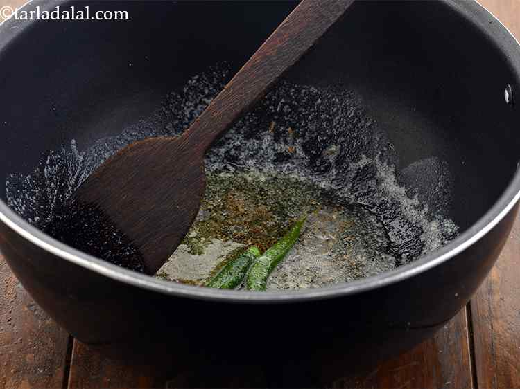 Step 13 – <p>When the seeds crackle add the slit green chillies and saut?. Doing so, the green …