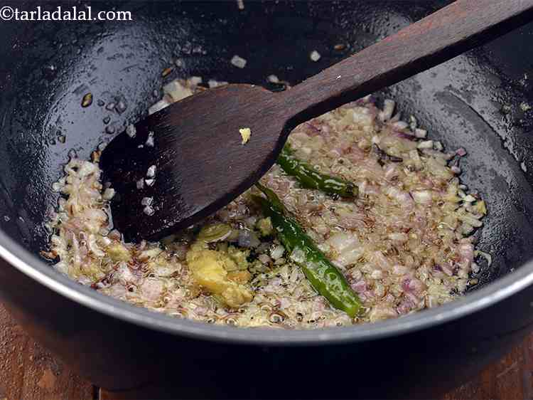 Step 19 – <p>The onions are now golden brown. Add the ginger-garlic paste. Ginger and garlic not only …