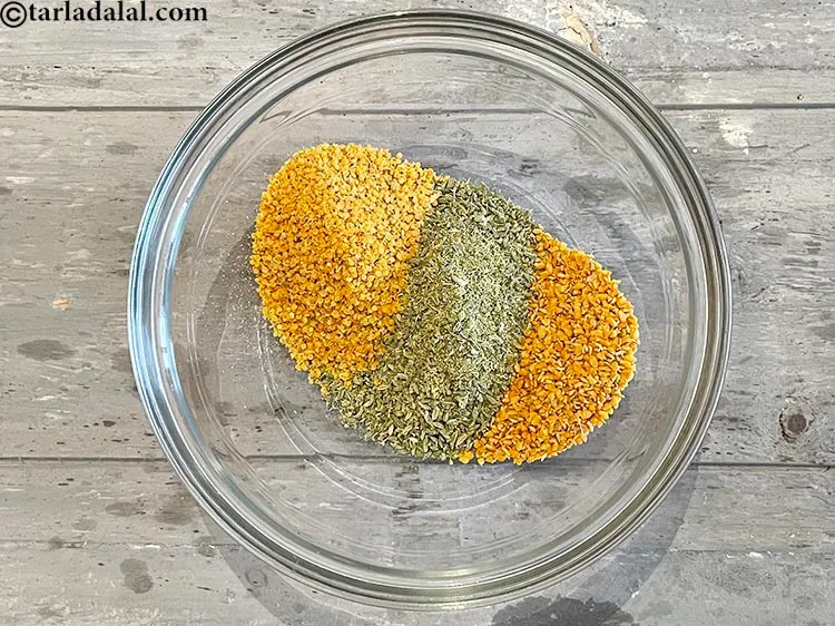 Step 18 – Add&nbsp;<meta charset="UTF-8" />1 tbsp&nbsp;<a href="glossary-split-fenugreek-seeds-methi-na-kuria-methi-dal-kuria-945i">split fenugreek seeds (methi na kuria)</a>.