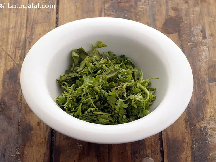 Step 11 – After achari mixture is cooled, add coriander leaves which would provide color and freshness to …