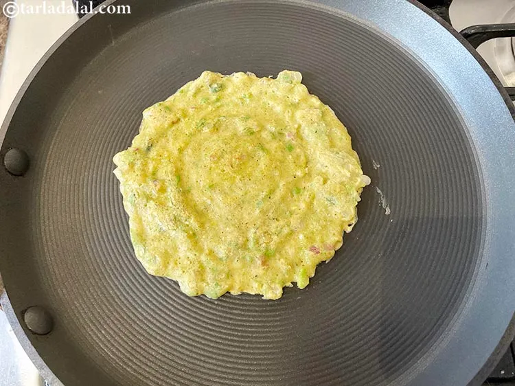 Step 25 – Smear 1/8 tsp of oil over it and along the edges and cook on a …