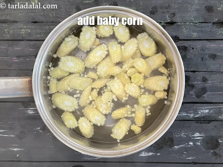 Step 5 – <meta charset="UTF-8" />Add&nbsp;diagonally cut&nbsp;baby corn.&nbsp;<br /> &nbsp;