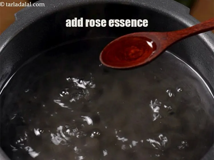 Step 16 – Add &frac12; tsp <a href="https://www.tarladalal.com/glossary-rose-essence-408i">rose essence</a>.