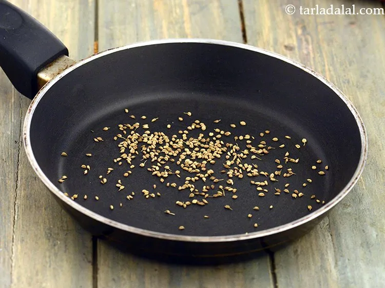 Step 4 – Place 1/2 tsp&nbsp;<a href="https://www.tarladalal.com/glossary-carom-seeds-ajwain-thymol-seeds-bishops-weed-266i">carom seeds (ajwain)</a> in a hot small non-stick pan and dry roast …