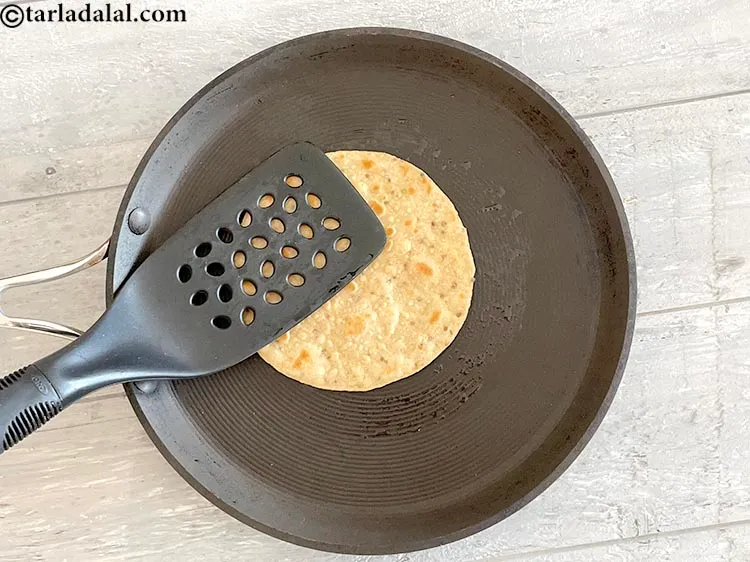 Step 22 – Cook roti applying a little downward&nbsp;pressure with a spatula.