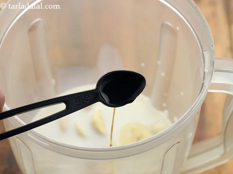 Step 5 – Add vanilla essence. It will give a nice flavour to our <strong>almond banana smoothie</strong>.&nbsp;
