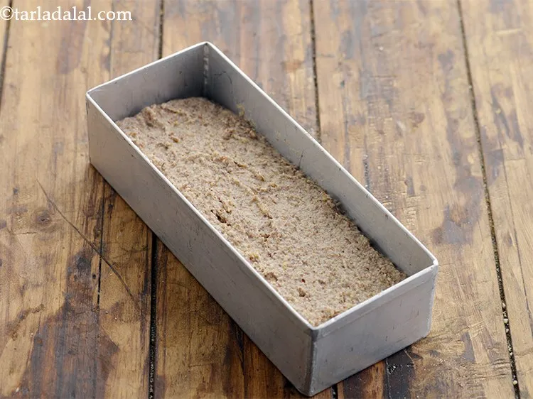 Step 16 – Pour mixture into the greased aluminium loaf tin. Smooth the top, but don&rsquo;t press down …