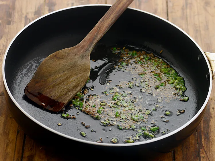 Step 15 – <p>When the seeds crackle, add the green chillies and sauté on a medium flame for …