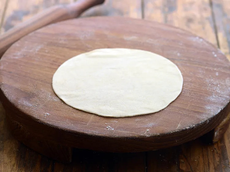 Step 8 – <p>Roll a portion of the dough into a 125 mm. (5”) diameter circle using a …