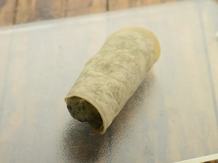 Step 33 – <p>Roll the roti tightly.</p>