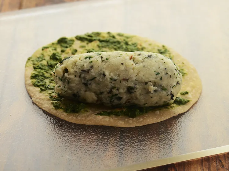 Step 31 – <p>Place 1 portion of the stuffing on one end of the roti. You can also …