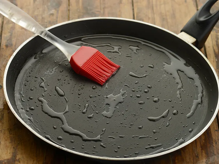 Step 35 – <p>Heat a non-stick tava (griddle) and grease it with 1 tbsp of oil . Butter …