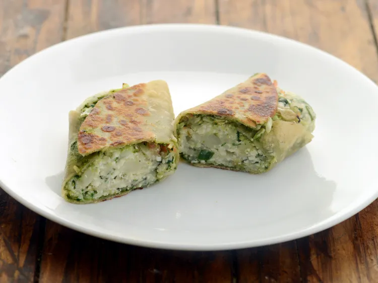 Step 40 – <p>Cut each paneer and aloo roll diagonally into 2.</p>