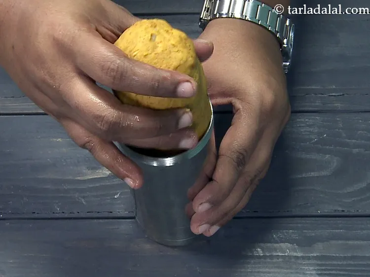 Step 39 – Put one portion of the dough in a greased &lsquo;sev press&rsquo;.