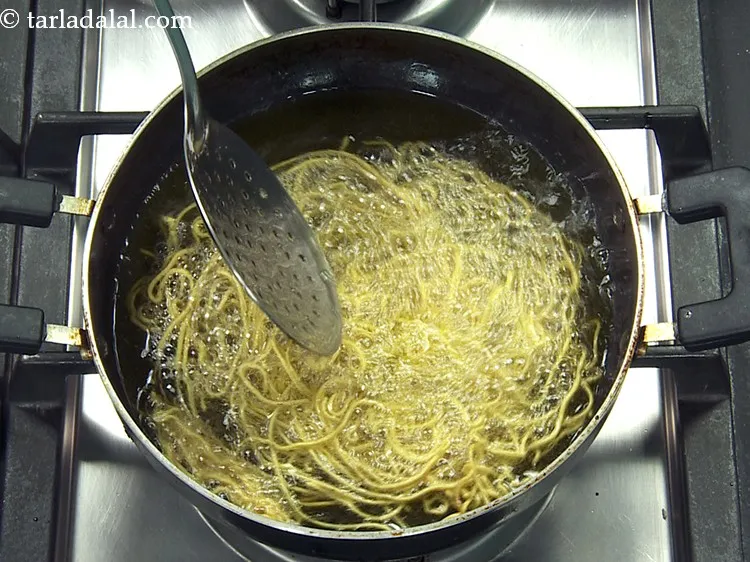 Step 44 – Deep-fry on a slow flame till they turn light brown in colour from both the …