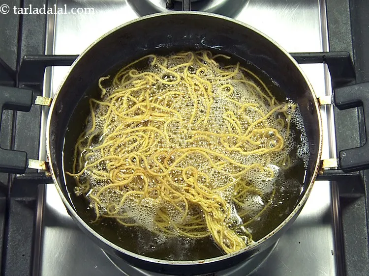 Step 45 – When the oil stops sizzling, it means the bhujia is ready. Also remove the sev …