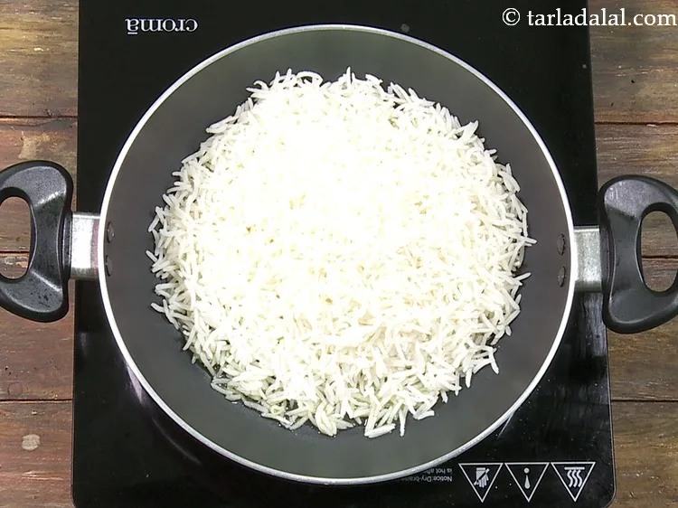 Step 30 – Add 3 cups&nbsp;<a href="https://www.tarladalal.com/glossary-soaked-and-cooked-long-grain-rice--1904i">cooked long grained rice (basmati)</a>.