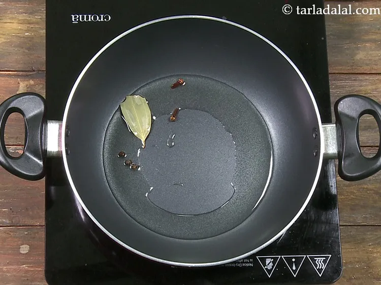 Step 48 – Add 3&nbsp;<a href="https://www.tarladalal.com/glossary-black-peppercorns-kali-mirch-kalimirch-566i">black peppercorns (kalimirch)</a>.