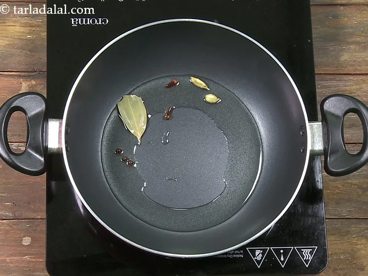 Step 49 – Add 2&nbsp;<a href="https://www.tarladalal.com/glossary-cardamom-elaichi-262i">cardamoms (elaichi)</a>.