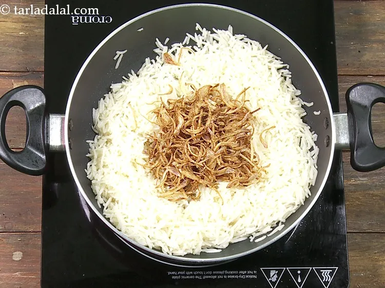 Step 33 – Switch off the flame and add 1/2 cup&nbsp;deep&nbsp;<a href="https://www.tarladalal.com/glossary-fried-onions-924i">fried onions</a>.