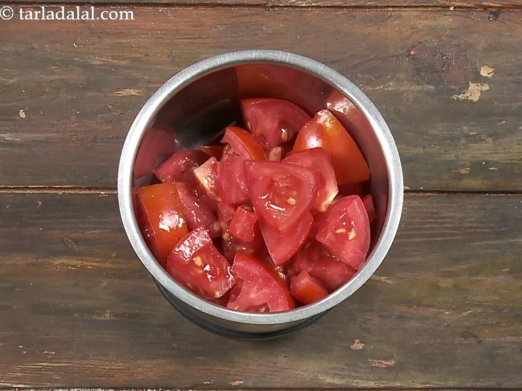 Step 35 – <strong>For the paste</strong>, add 1 cup&nbsp;roughly&nbsp;<a href="https://www.tarladalal.com/glossary-chopped-tomatoes-779i">chopped tomatoes</a> in a mixer jar.