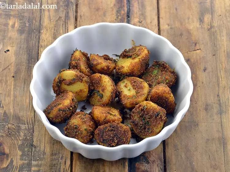 Step 21 – For making the <strong>Mumbai roadside aloo chaat recipe</strong>, place &frac12; the cooked potatoes in a …