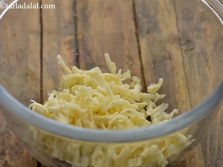 Step 9 – For preparing the Cheesy Stuffing for <strong>Aloo Cheese Croquettes</strong>, in a deep bowl take grated …